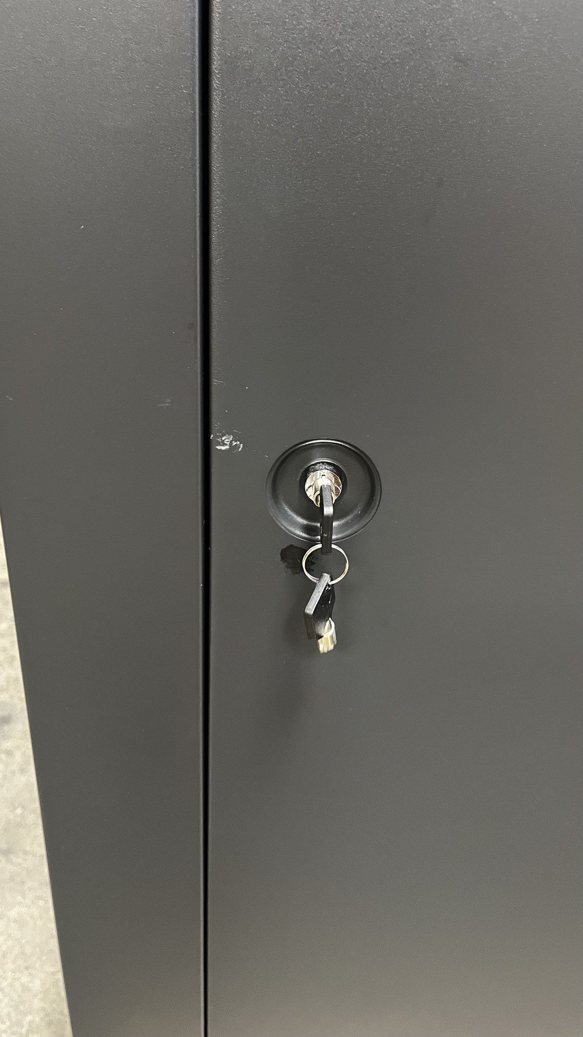 Close up view of the Key lock and small scratch alongside the edge of the door. 