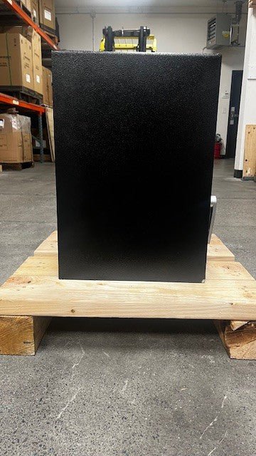 Left side view of the safe, the lower corner has a chip on the paint. 