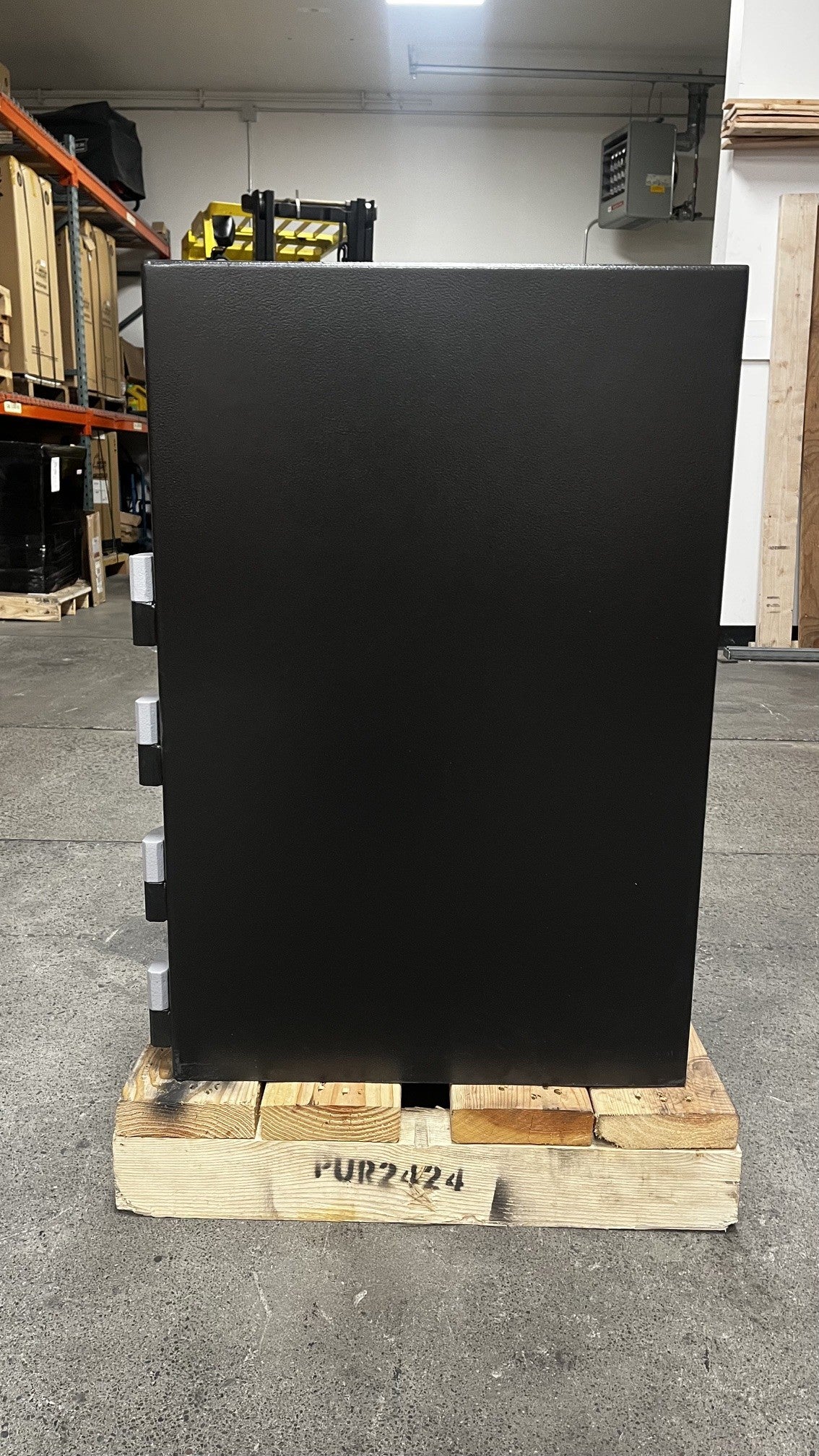 View of the right side of the safe. The bottom left corner has a small scratch on the paint. 
