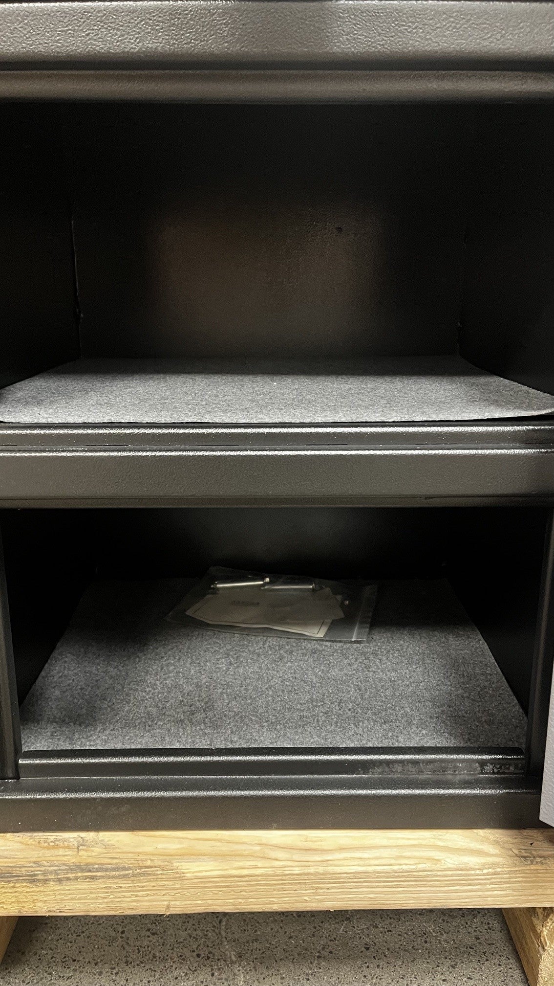 View of the inside of the safe. The top area is where the drops will go into. The bottom area could be used as storage. 