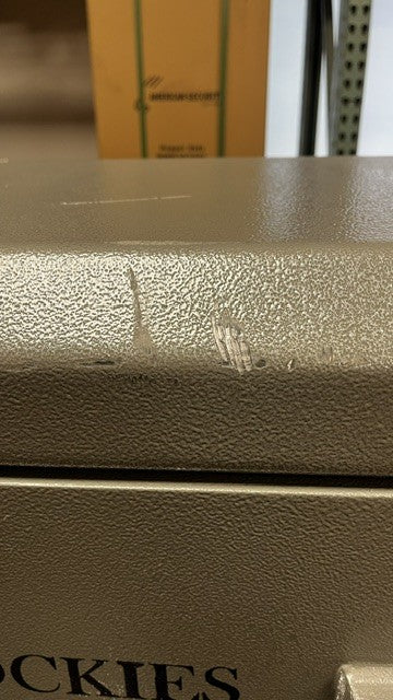 View of the top front of the safe. It does have a few scratches on the paint. 