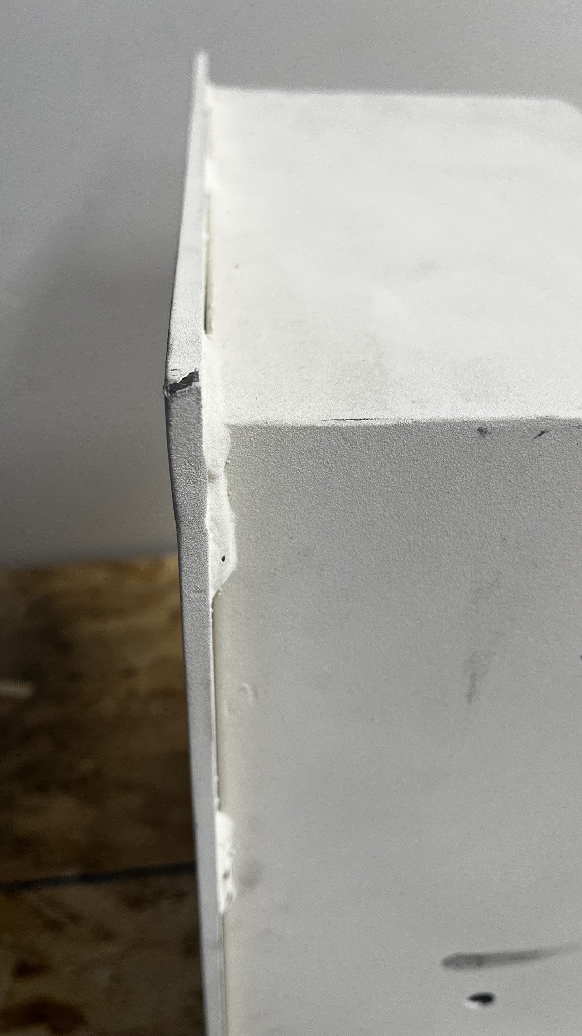 View of the top right corner on the flange. It has a small chip on the paint. 