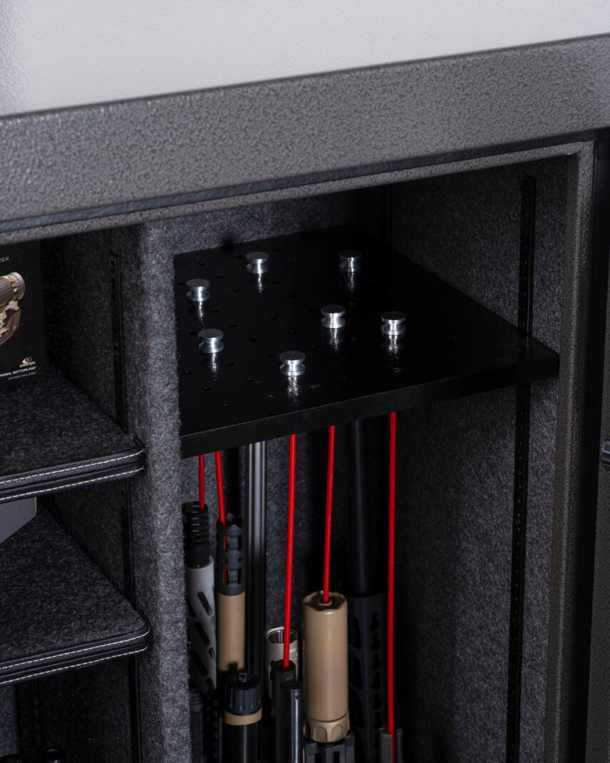 Winchester Bandit 19 GunStiXX rack top plate holding red rifle spacers over mixed long gun barrels in main compartment