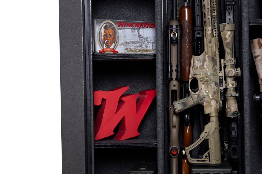 Winchester Bandit 31 interior with vintage Winchester tin, red W logo on adjustable shelf, and camo rifles on GunStiXX