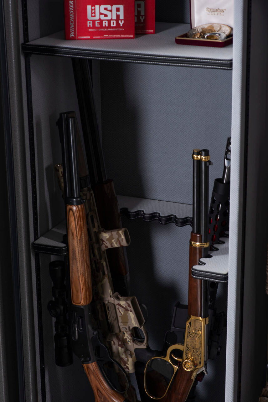 Winchester Big Daddy XLT interior with a scoped bolt-action rifle and gold-accented lever-action on the barrel racks