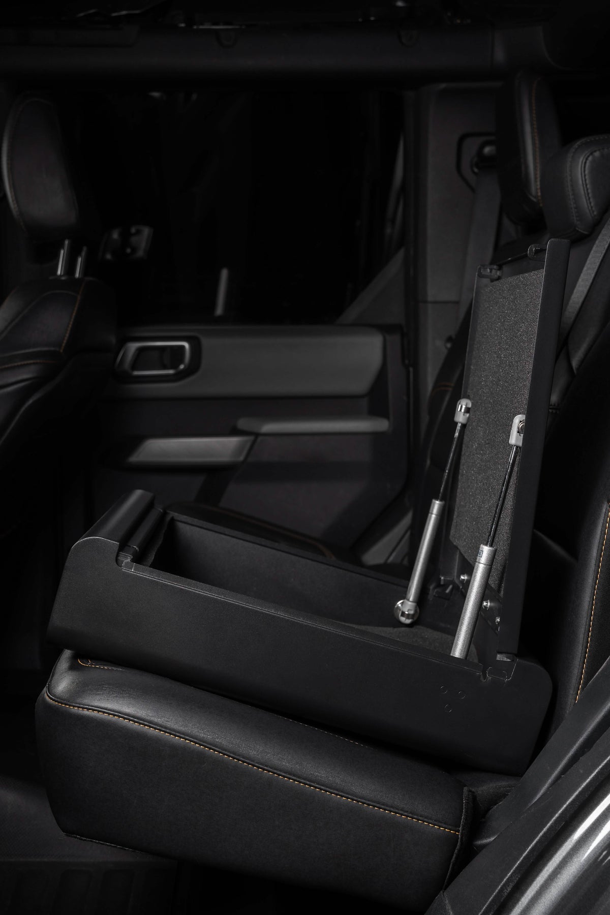 Black leather car interior with folded seat backrests