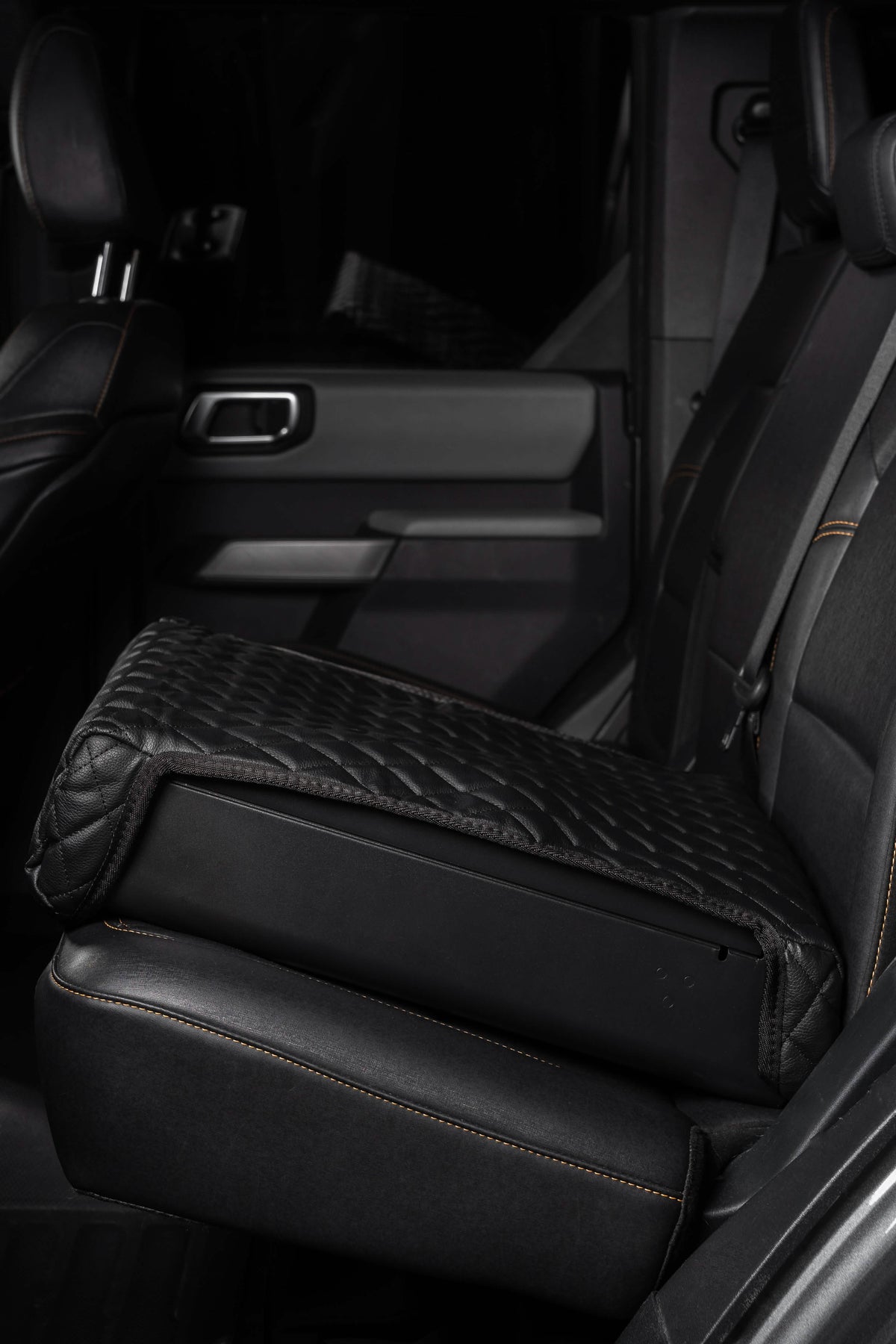 Black quilted car seat cover on a vehicle seat