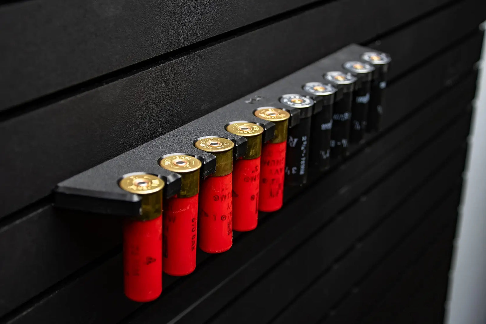 Row of shotgun shells on a black surface