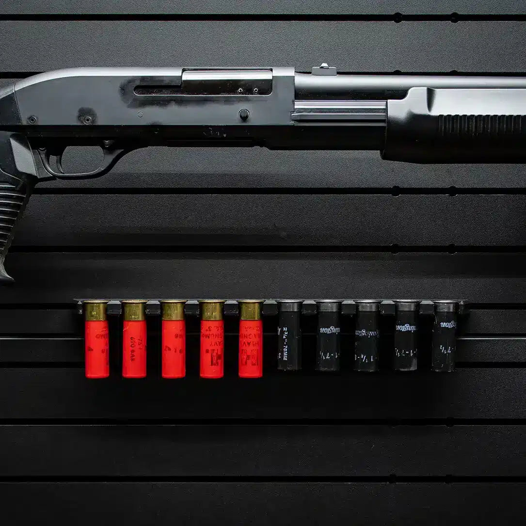 Row of shotgun shells on a black surface