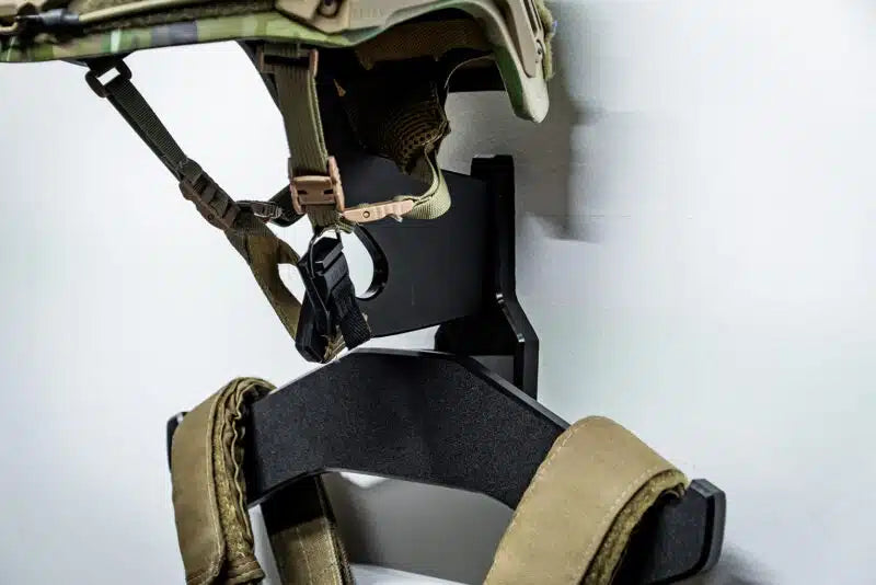 Close-up of a tactical helmet and harness on a white background