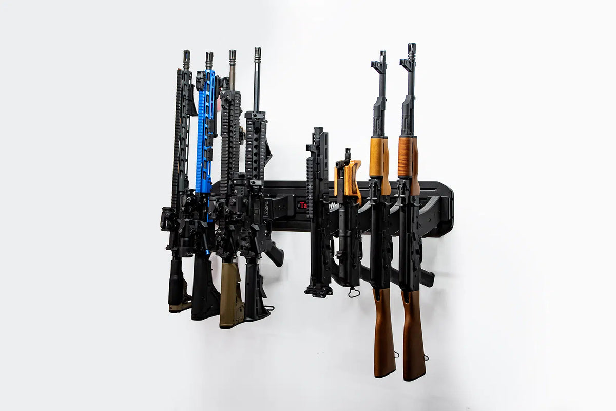 Wall-mounted gun rack holding multiple rifles on a white background