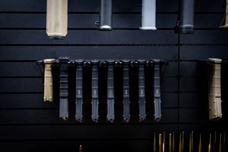 Set of rifle magazines on a dark wall