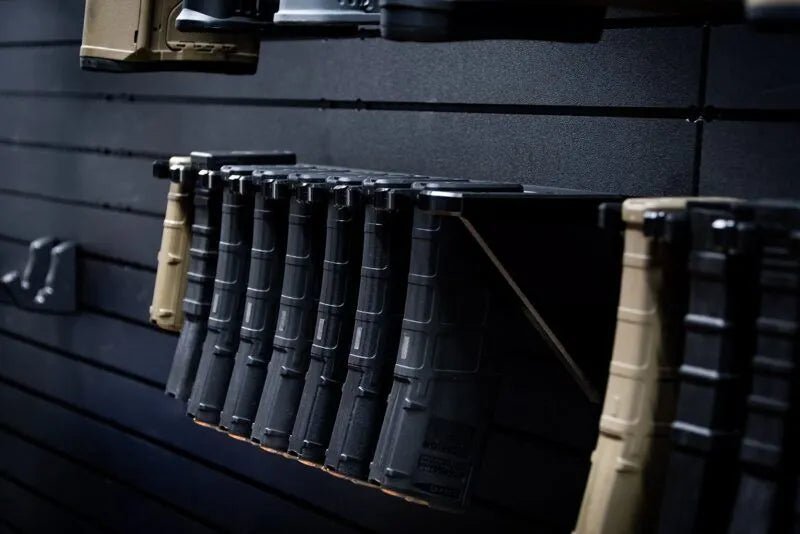 Row of rifle magazines on a dark wall