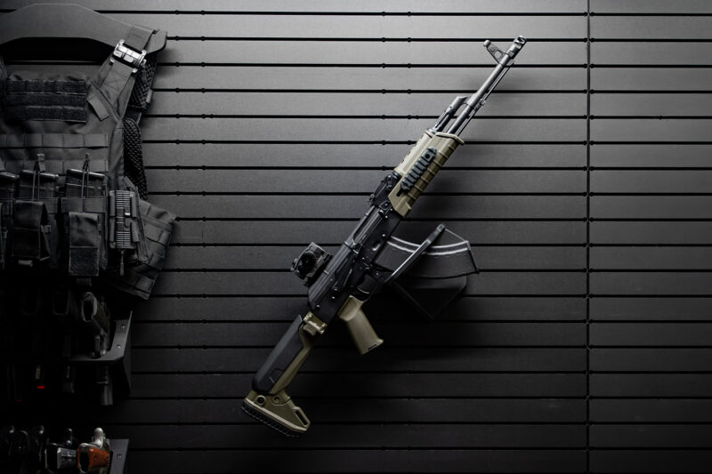 Rifle and tactical gear on a black ModWall panel