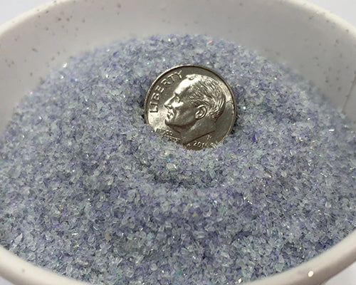 Formax FD-8714HS shredded disc output sample showing tiny 2mm by 2mm purple particles in a bowl with a US dime for scale, demonstrating NSA-approved destruction particle size