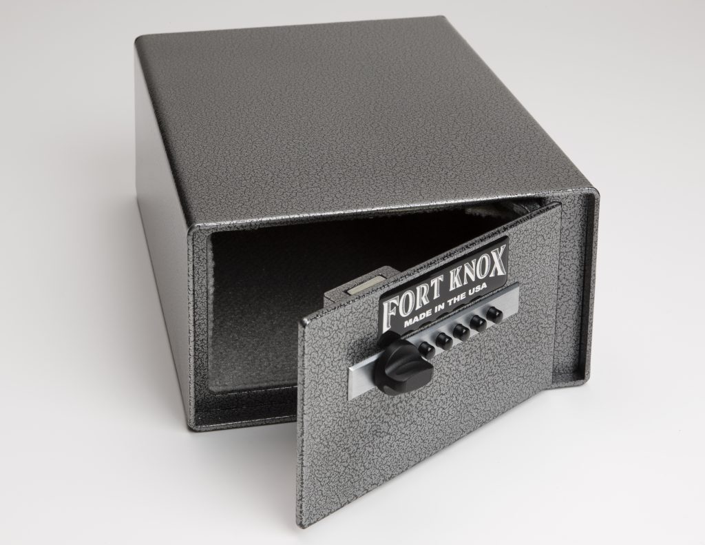 Fort Knox PB4 Personal Pistol Safe shown from above with the frontdoor partially extended, Simplex pushbutton mechanical lock on the door face, and silver hammertone painted steel body