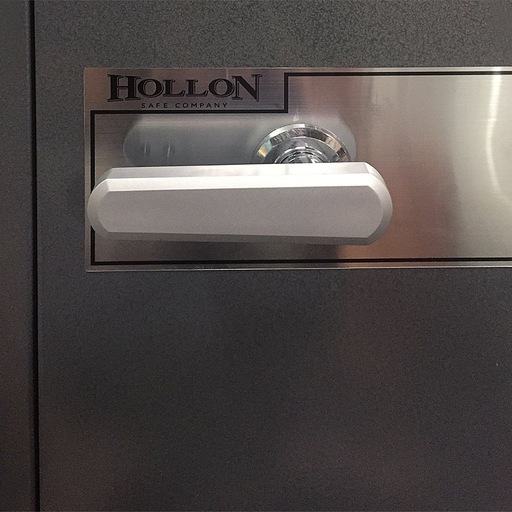 Close-up detail of the Hollon HS-750E office safe door showing the S&G digital electronic keypad, chrome three-spoke handle, and lock cylinder on the solid gray steel door face