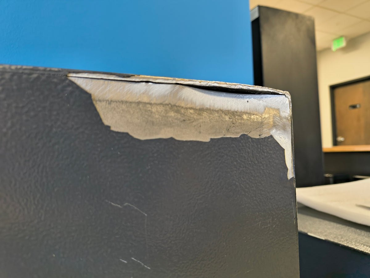 Blemished Protex FDD-3214 II damage to back top right corner of safe where the steel has split causing a potential security vulnerability. 