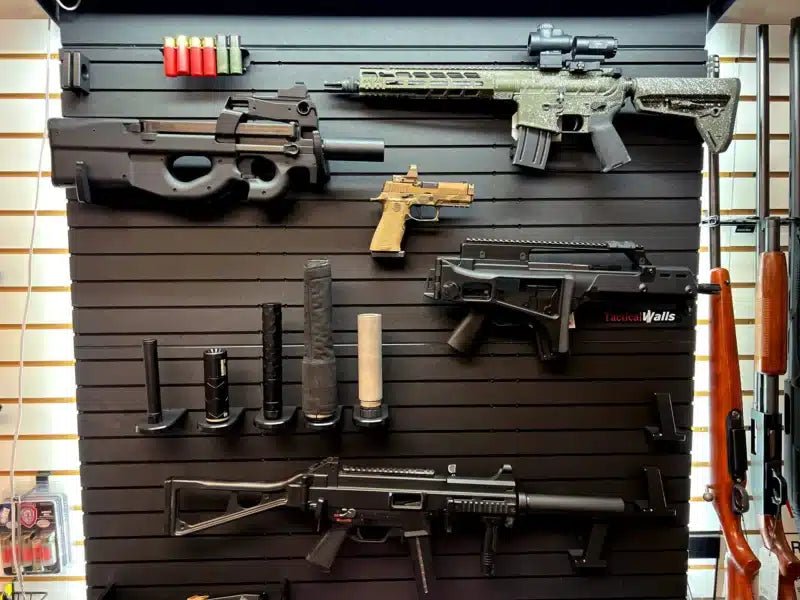 Tactical Walls ModWall Suppressor Holder mounted on a ModWall tactical storage wall, organizing suppressors and firearms accessories
