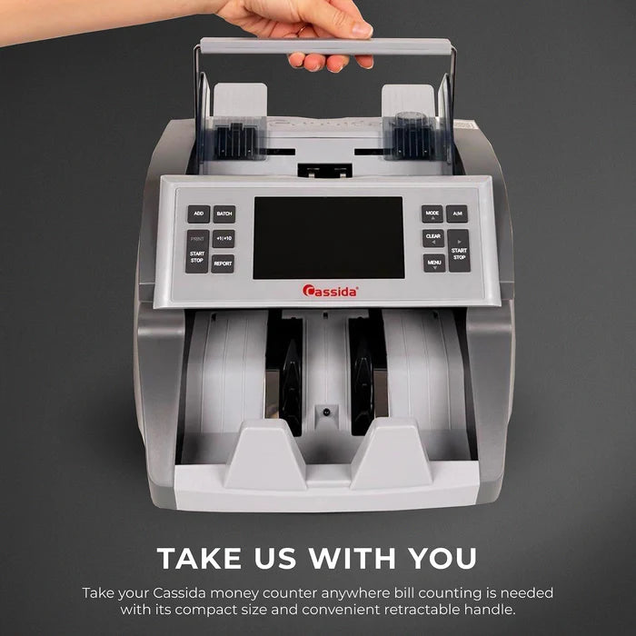 Cassida CRS 7500 being carried by the retractable handle, showing compact size for portable bill counting