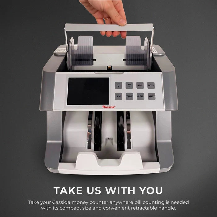 Cassida CRS 6200 bill counter being lifted by built-in carrying handle for easy portability between counting stations