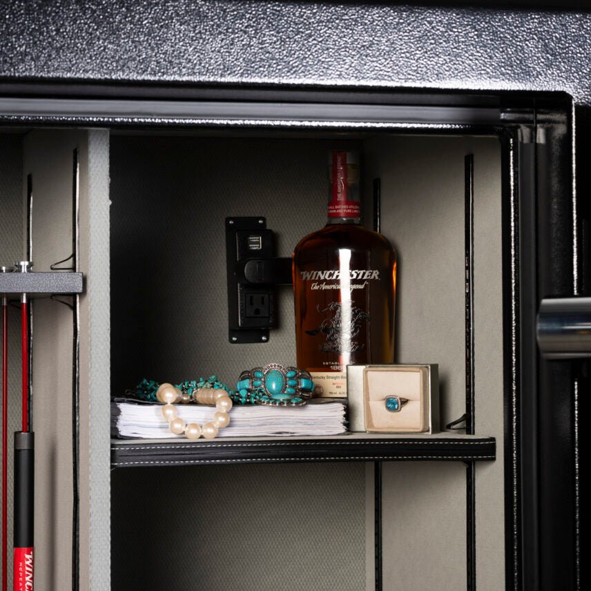 Winchester Legacy 62 interior with a Winchester bourbon bottle, turquoise jewelry, and Power Docking System outlets