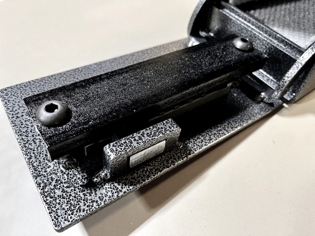 Close-up interior detail of the Fort Knox PB4 door showing the mechanical Simplex latch bolt mechanism, back plate, and hardened mounting hardware that engages the safe body to lock the door closed
