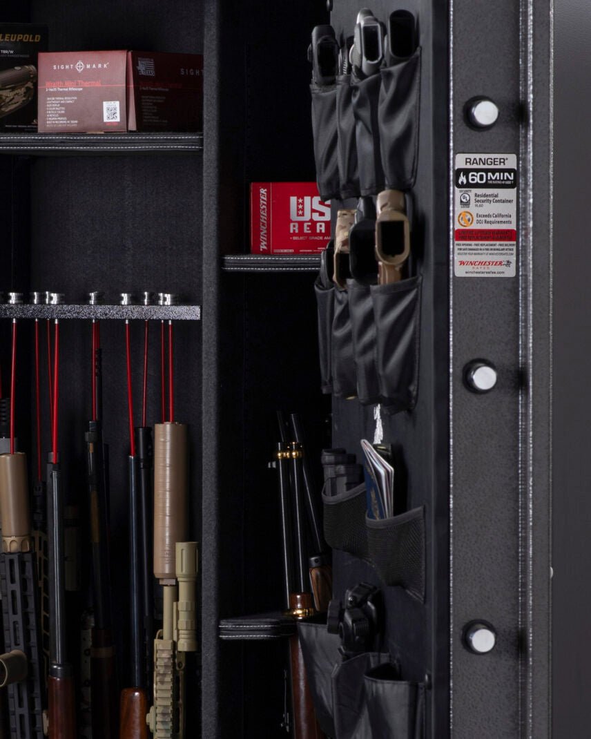 Interior close-up of the Winchester Ranger 66 with Leupold and Sightmark optics boxes, Winchester ammo, and GunStiXX storage
