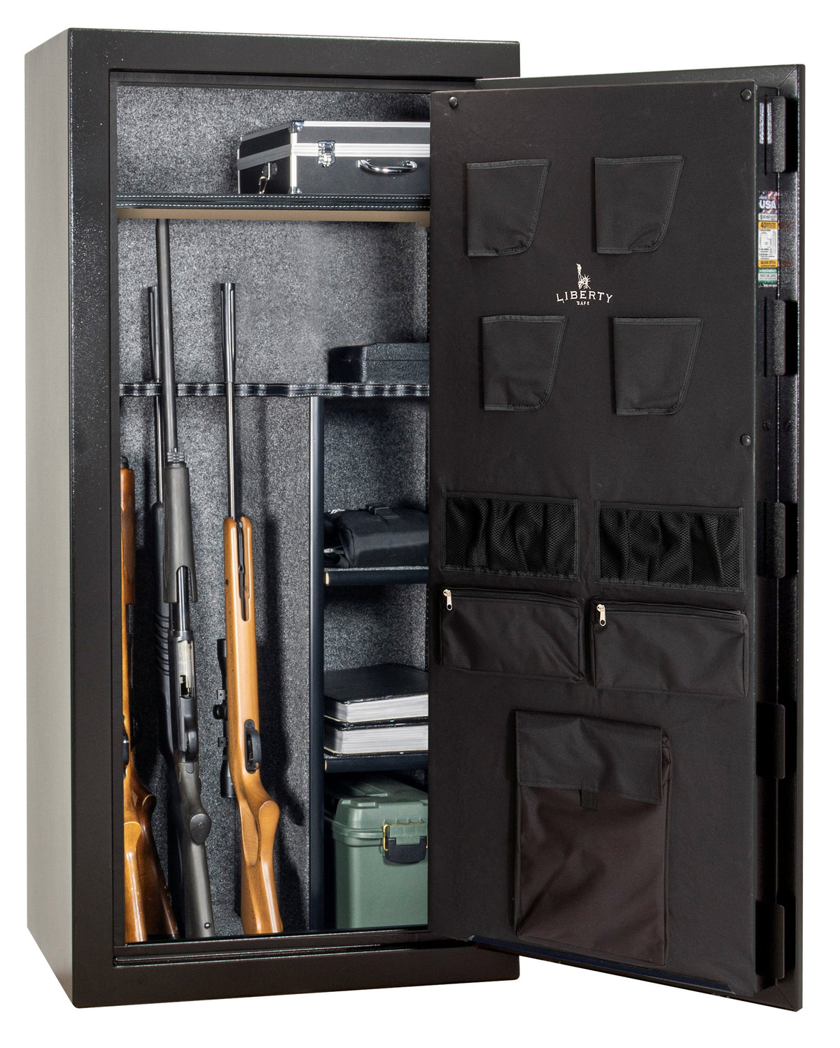 Liberty Safe Revere 30 gun safe with door open showing two rifles in rack, aluminum case, binoculars, ammunition, documents, and books on shelves, with Liberty-branded canvas door panel storing pistols and papers