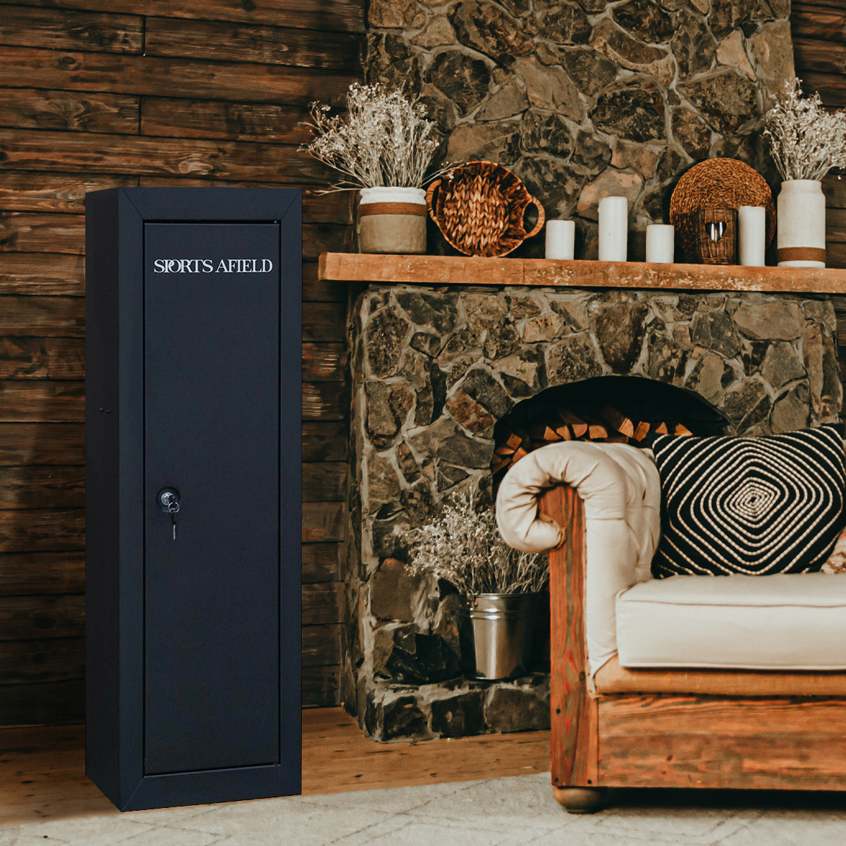 Black safe box labeled 'Sports Afield' next to a stone fireplace with decorative items.