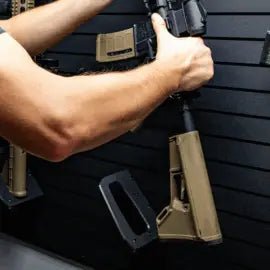 Person holding a rifle with a black background