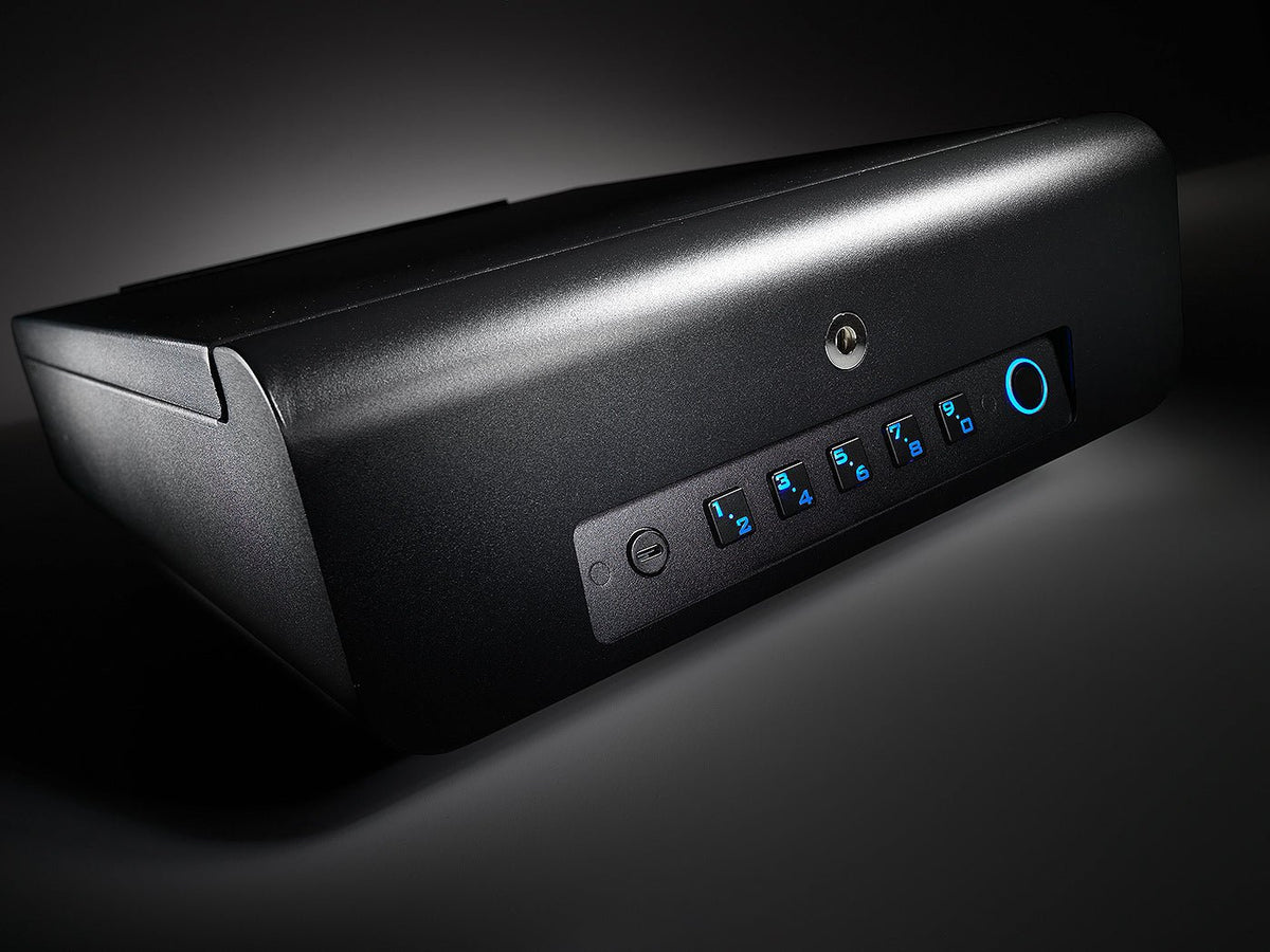BoostedSafe Elite Biometric Vehicle Gun Safe angled view showing blue-lit digital keypad, key lock cylinder, and fingerprint sensor on matte black exterior