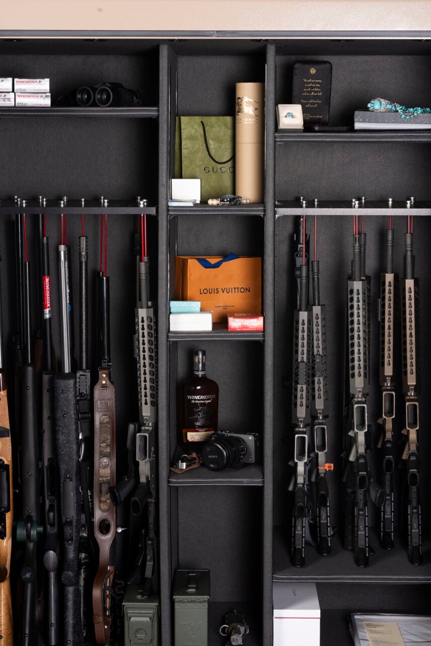 Interior view of the Winchester Grand American with scoped hunting rifles, tactical rifles, ammo, and luxury accessories
