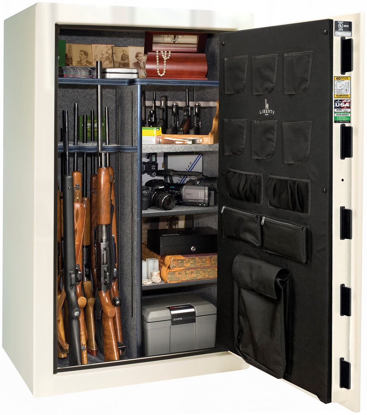 Liberty Safe We The People 44 gun safe in white with door open showing multiple rifles in rack, ammunition, camera, pearls, jewelry, framed photos, and cash box on shelves, with Liberty-branded canvas door panel storing pistols and documents