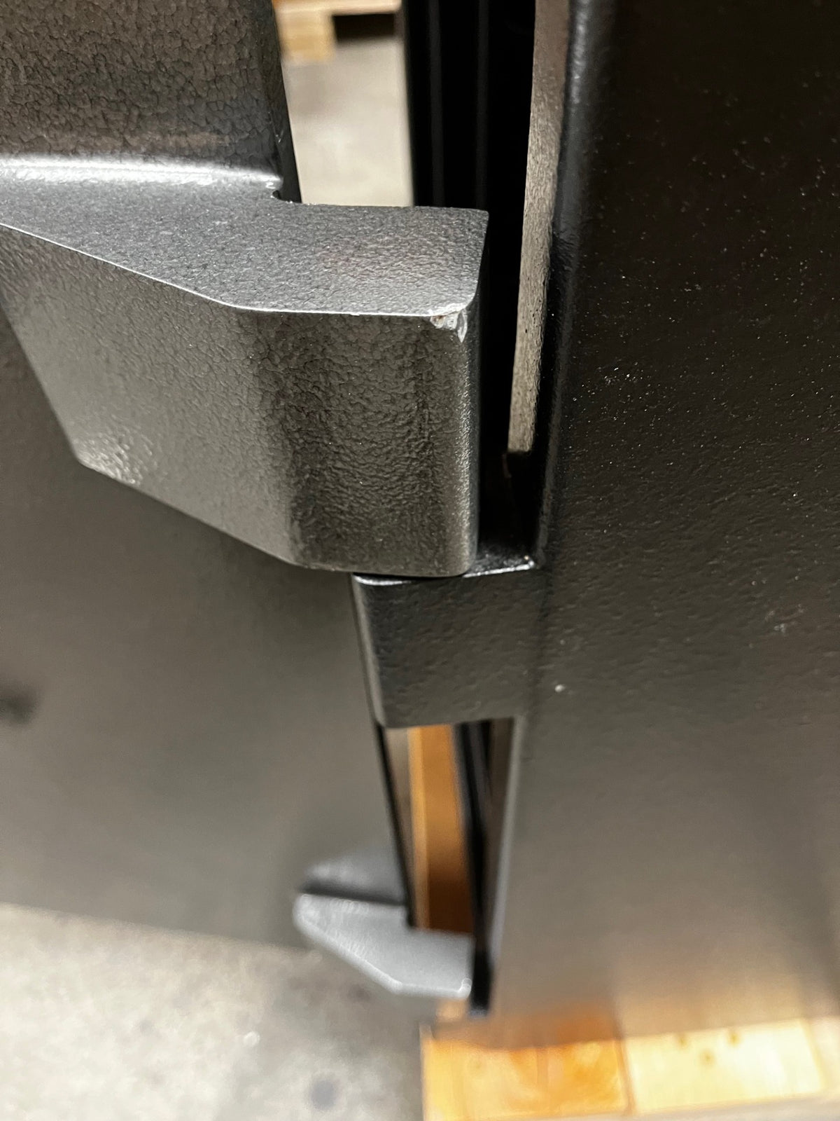 Close-up view of the right top hinge. The hinge has a small scratch on the corner. 