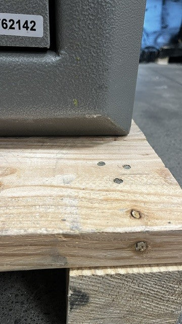 View of the lower front right corner. It does have small scratches alongside the edge. 