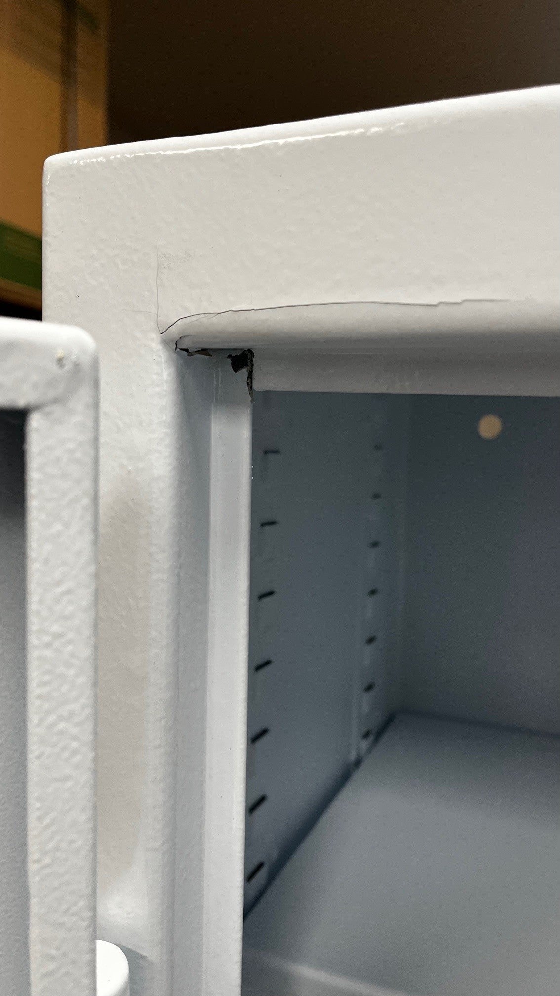 Chip on the left top corner of the door frame. 