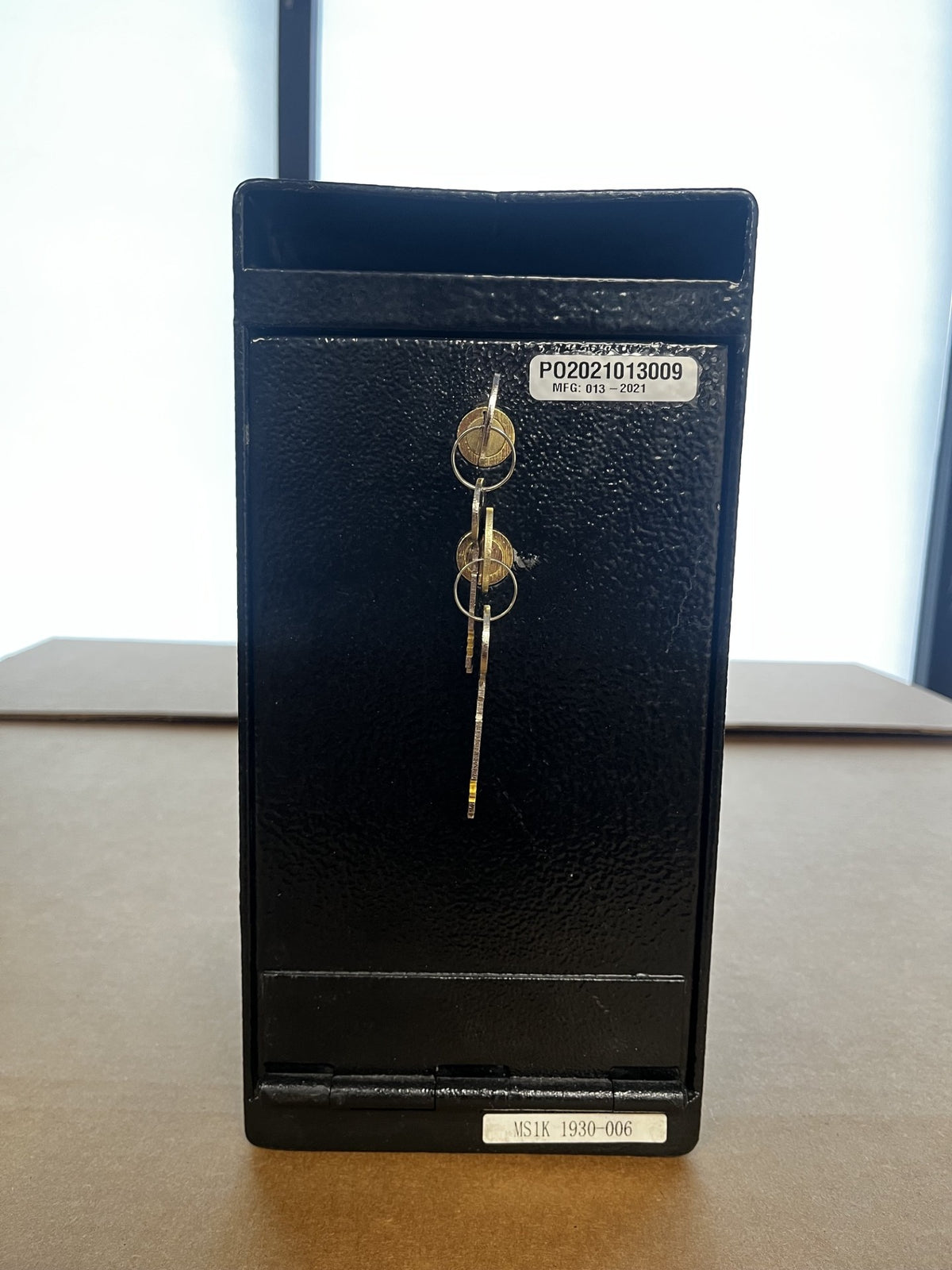 View of the front of the safe with the keys inside. Both keys are needed to open the safe. 