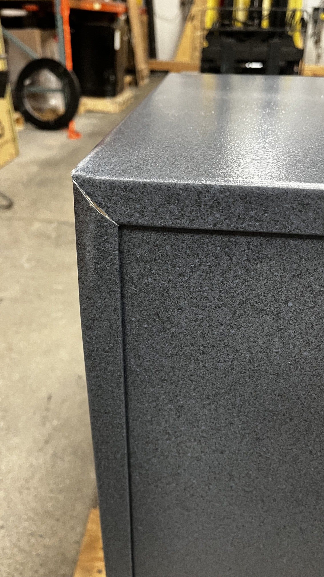 Close up view of the top left corner where it has a small crack. 