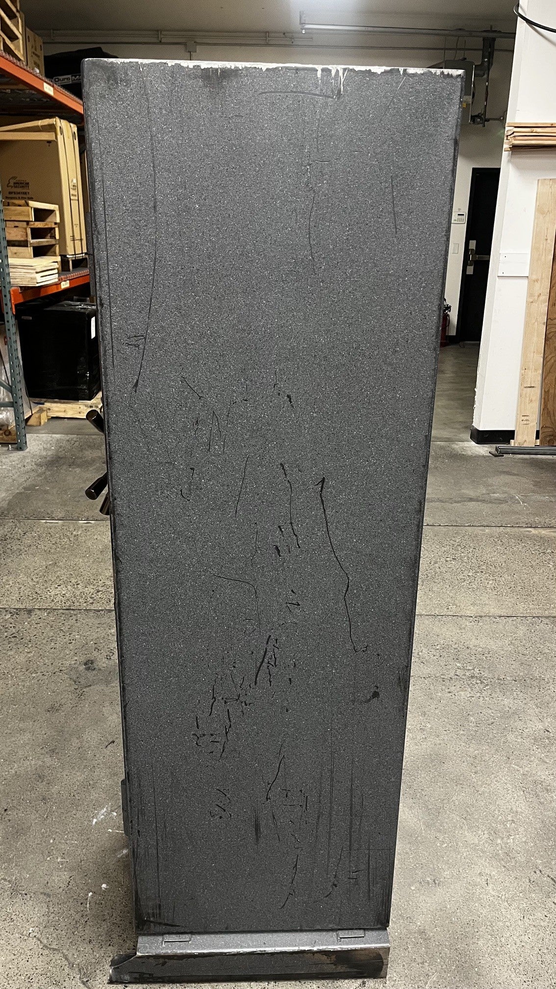 Right side view of the safe. The right side has a significant number of scratches. 