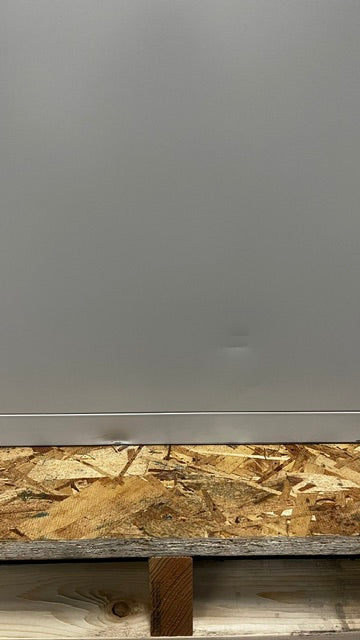 The left side has two small dents near the lower area of the file cabinet. 