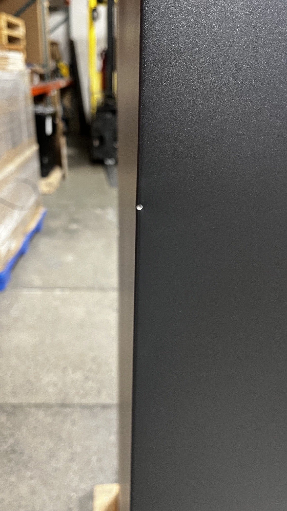 View of a chip on the safe alongside the edge of the safe. 