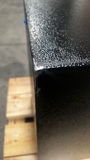 Close-up view of the damaged paint on the top corner. 