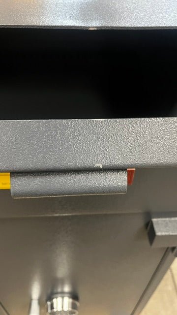 View of the drop chut door with a small chip on the front edge. 