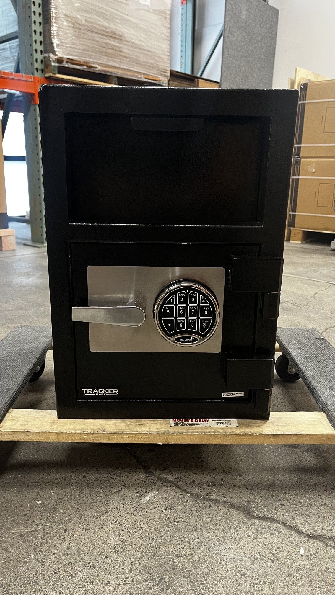 Front view of the safe. Both top and bottom corners have a dent on them. 