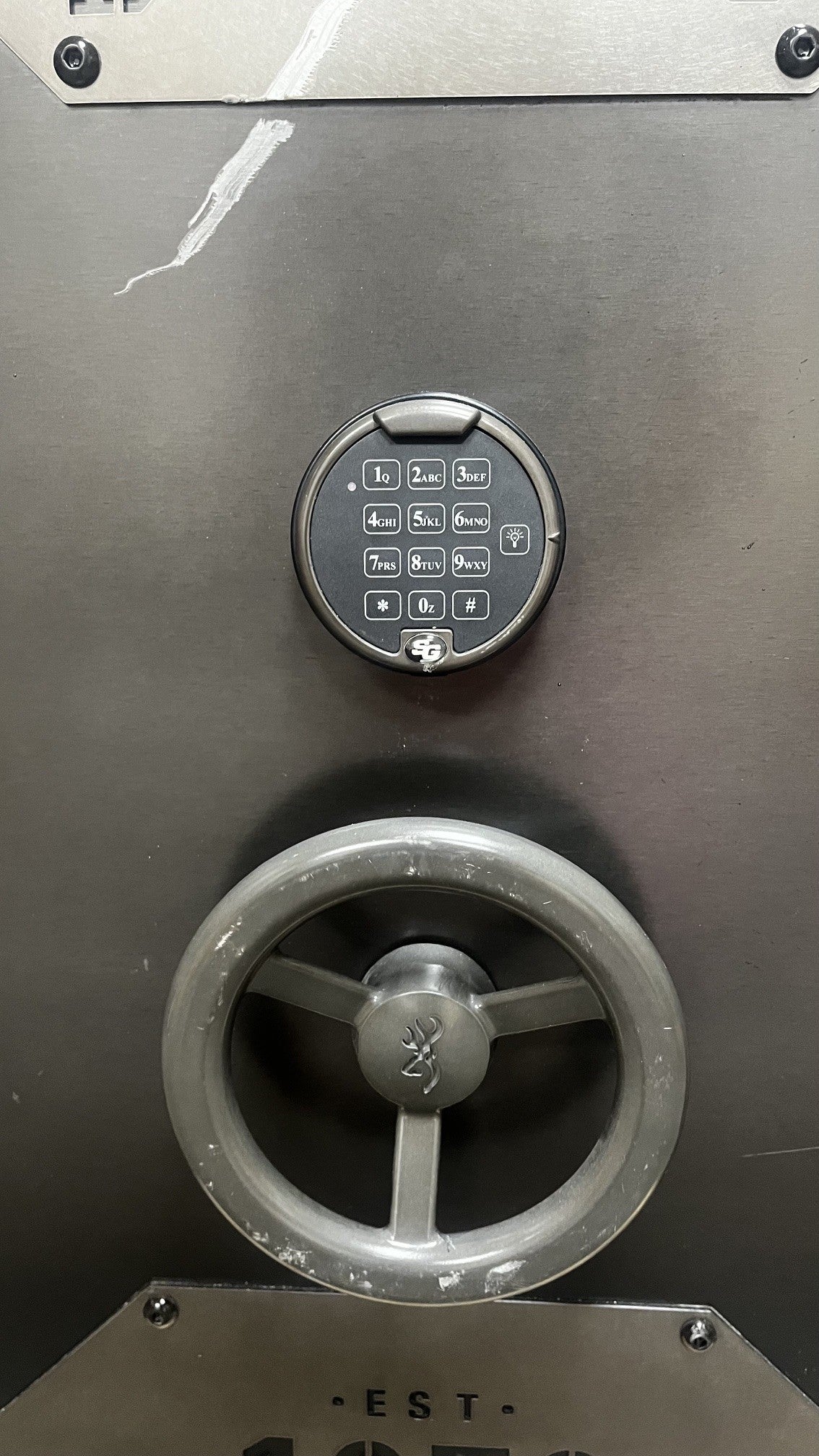 Close-up view of the S&G digital lock. The turn wheel has scratches on it.  