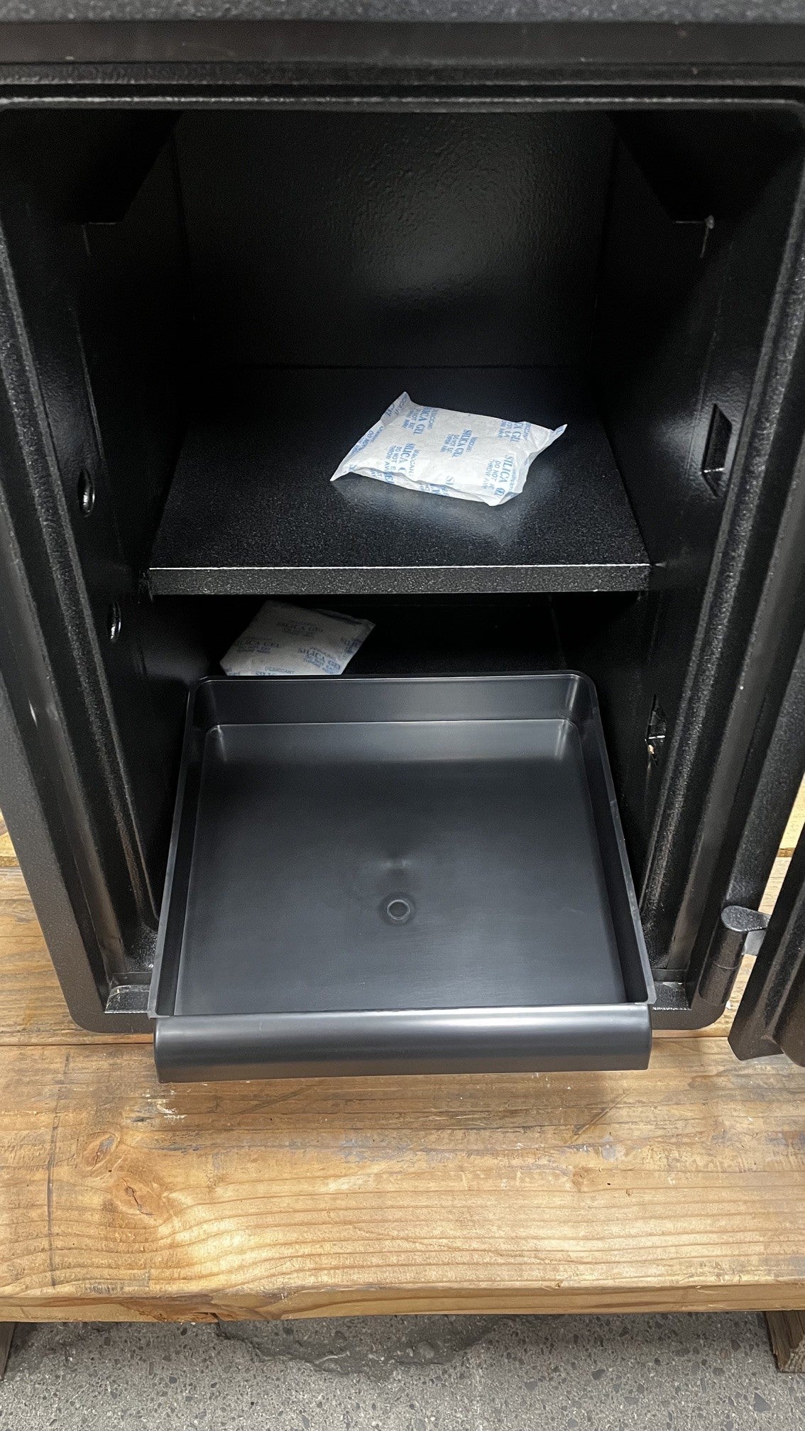 Close-up view of the top tray and adjustable shelf. 