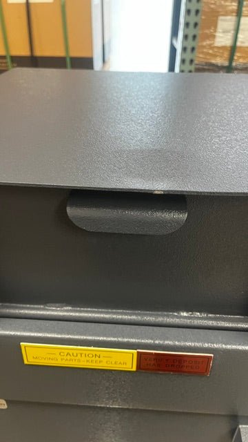 The top area of the where the chut drops down has a small dent and chip on the paint. The door does come all the way down. 