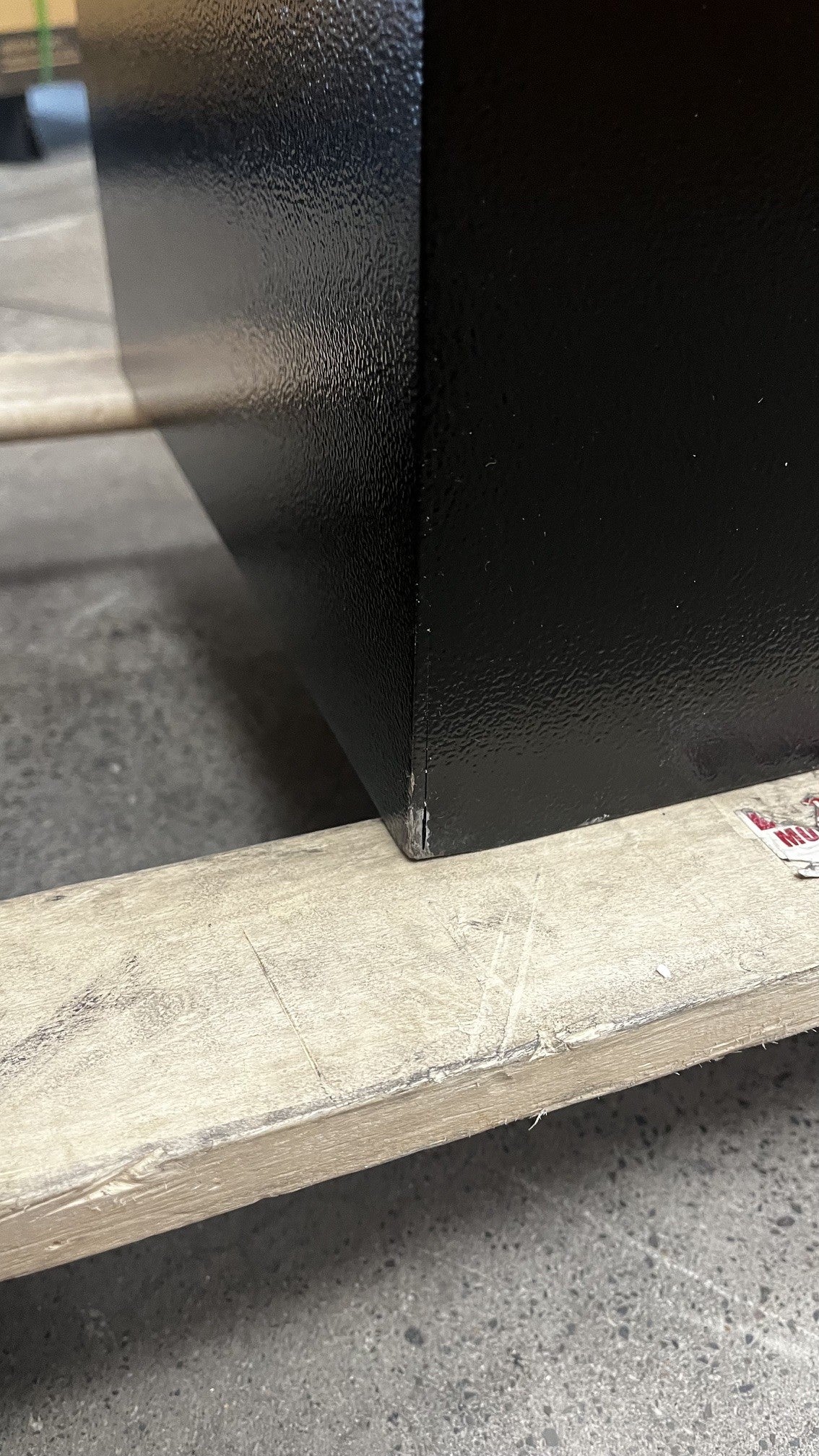 View of the lower left corner with chips on the paint. 