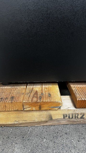 The lower edge of the safe has a few chips. 